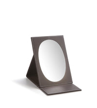 A large oval foldable mirror with a chocolate brown leatherette frame.
