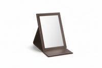 A large rectangle foldable mirror with a brown frame, standing upright on a flat surface.