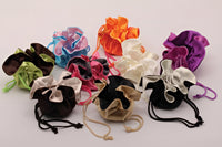 Colorful velvet drawstring bags on a white background