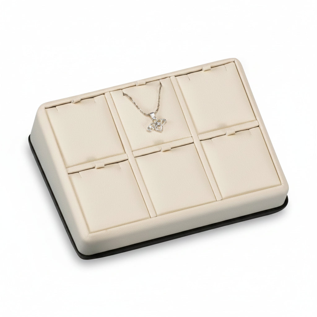A chocolate and beige leatherette 6 pendant stand with a cushioned interior displaying a single necklace.