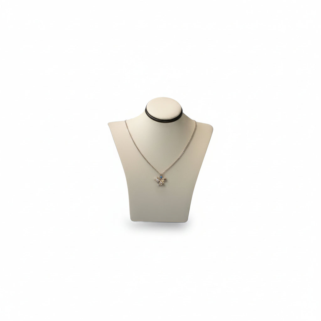 A small neckform with a chocolate and beige leatherette finish, displaying a necklace.