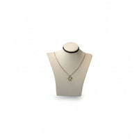A small neckform with a chocolate and beige leatherette finish, displaying a necklace.