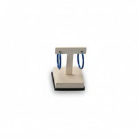 An image of a chocolate and beige leatherette short earring stand with a square base and a soft, cushioned surface.