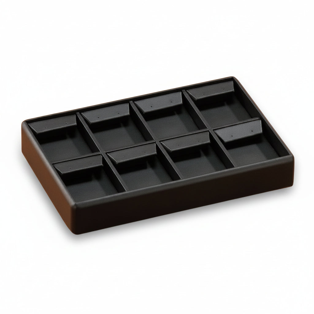Black leatherette drop earring tray with multiple compartments.