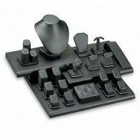 A black leatherette window display set with various mounting blocks and accessories, designed for organizing and presenting jewelry or small collectibles.