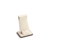 A chocolate and beige leatherette earring or ring stand with a sleek design, isolated on a white background.