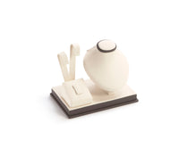 A chocolate and beige leatherette earring, ring, and pendant stand with various slots and compartments for jewelry display.