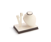 An image of a chocolate and beige leatherette earring/pendant stand with a white cushion on top, isolated on a white background.