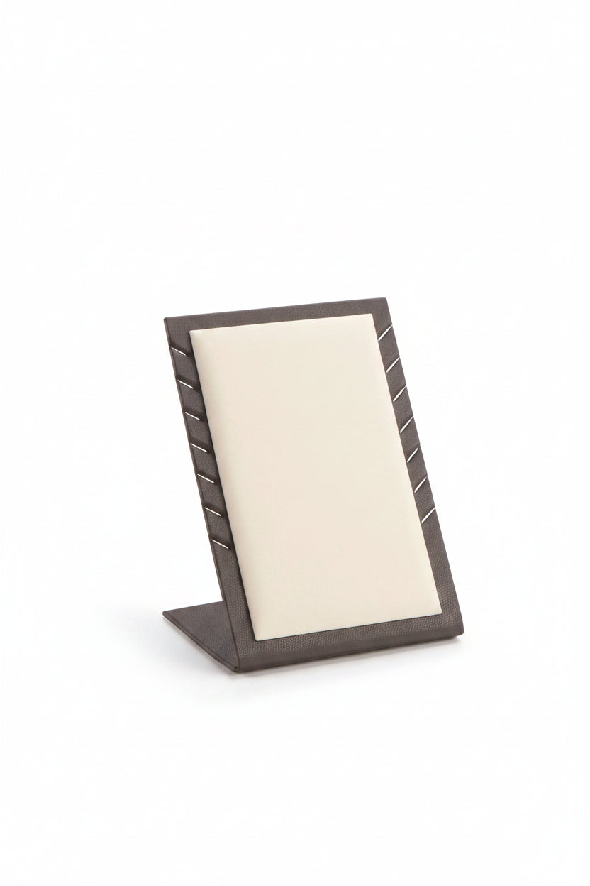 A chocolate and beige leatherette 7 pendant stand designed to hold pendants for display.