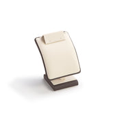 An image of a chocolate and beige leatherette earring/pendant stand with a square base, designed to hold jewelry.