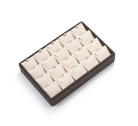 A chocolate and beige leatherette pendant tray with multiple compartments, designed for displaying jewelry.