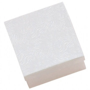 A white cotton filled jewelry box with a swirl pattern on the interior lid.