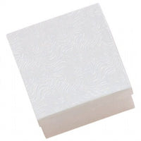 A white cotton filled jewelry box with a swirl pattern on the interior lid.