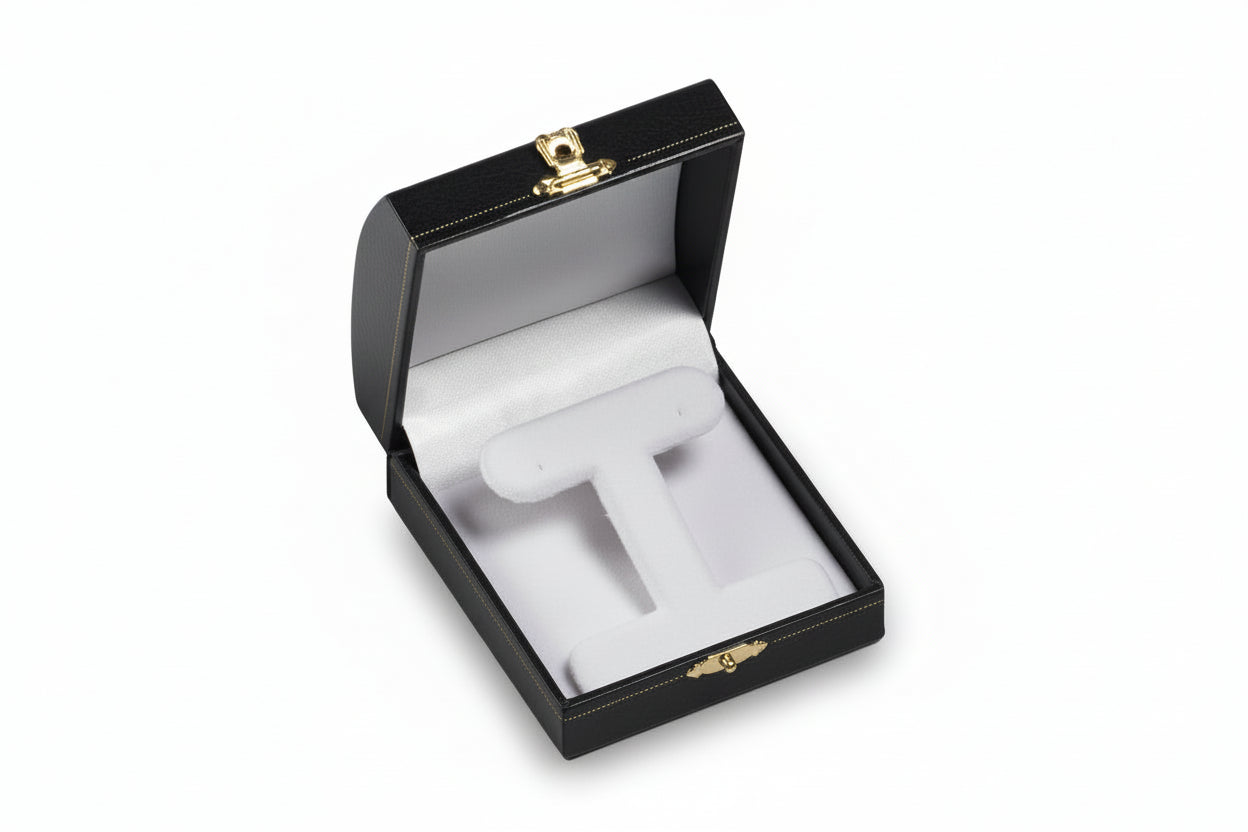 Open jewelry box with a ring on a white background
