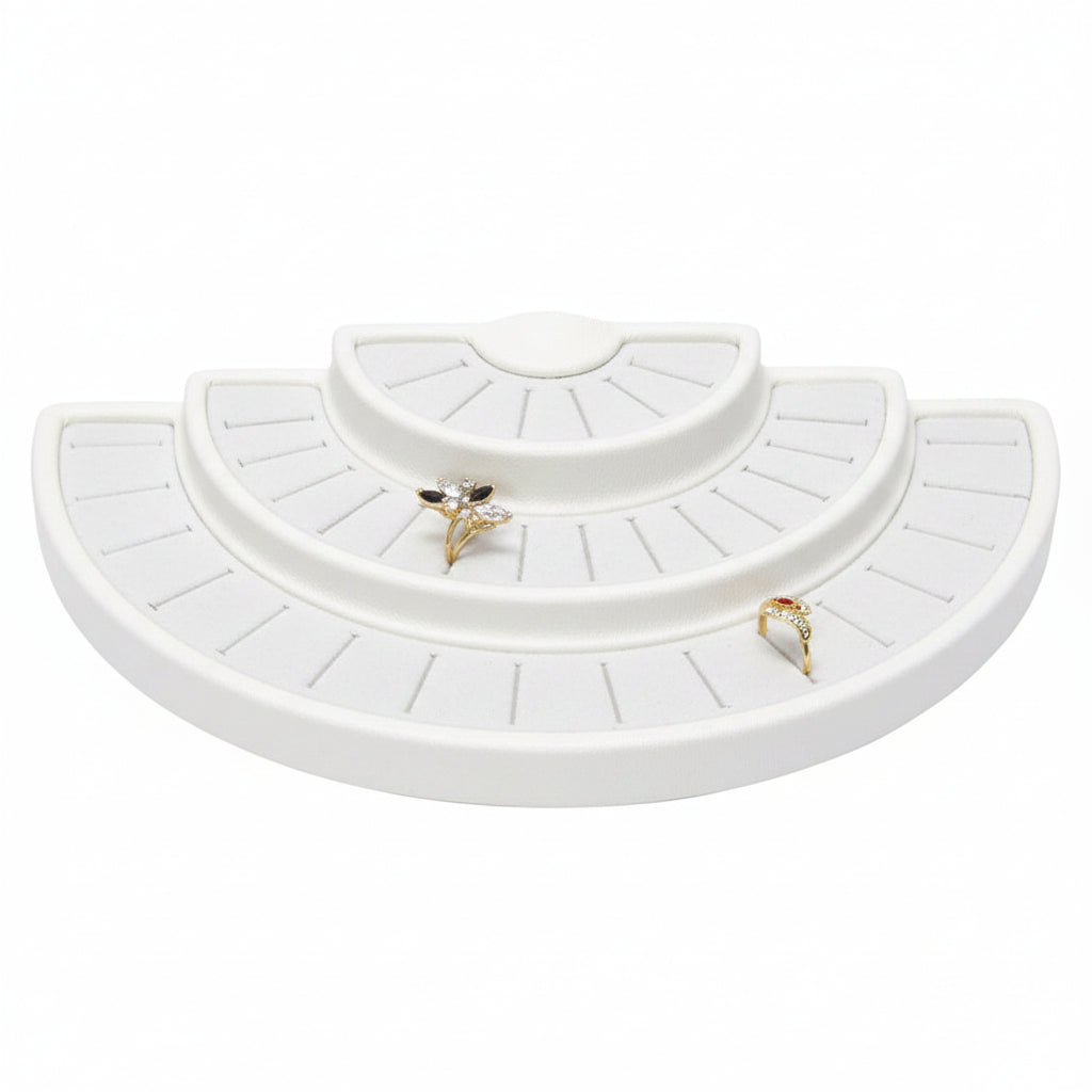 Set of white jewelry trays with two gold rings 