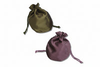 Two round satin drawstring pouches, one in gold and one in purple color, with drawstrings tied to close them.