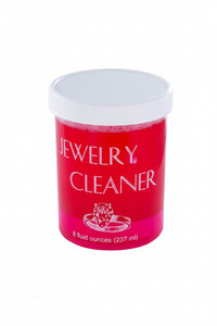 Red container of jewelry cleaner with white lid on a white background