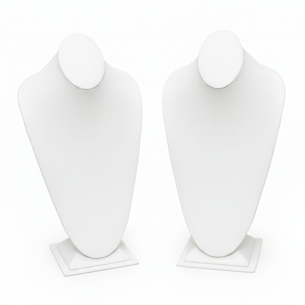 Black and white mannequin busts on stands against a white background