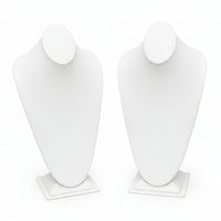 Black and white mannequin busts on stands against a white background