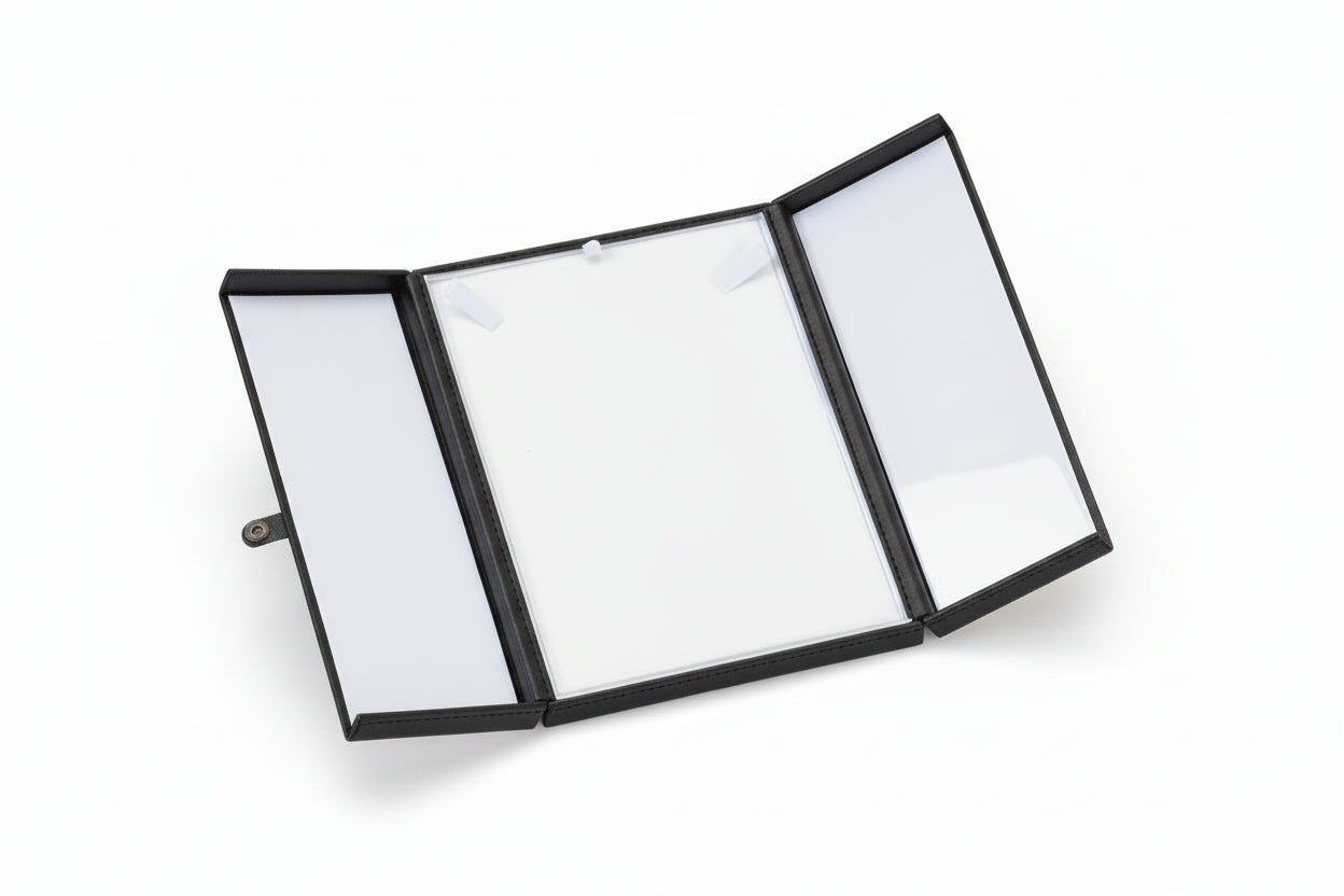 Open leather-bound notebook with blank pages on a white background