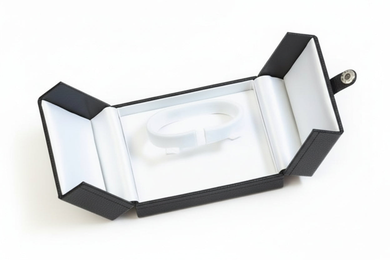 Open jewelry box with a white interior on black background