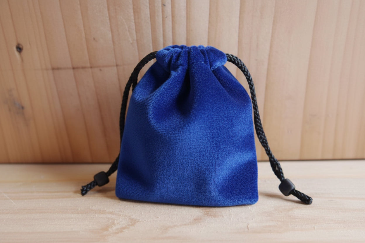 Blue drawstring pouch on a wooden surface