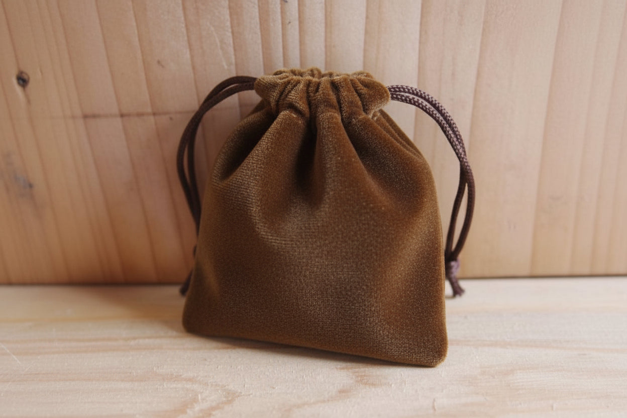 brown drawstring pouch on a wooden surface