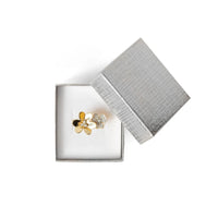 silver floral earrings in a Silver jewelry box 