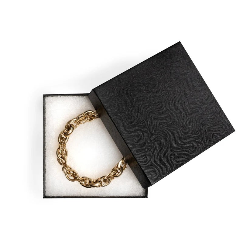 Chain bracelet in an open black jewelry box 