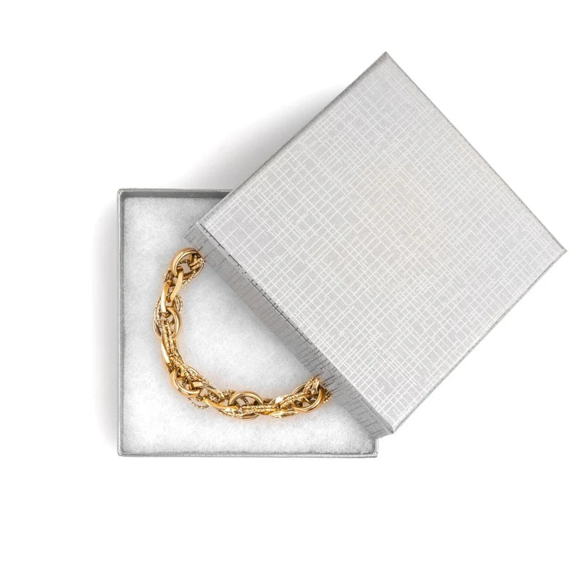 Chain bracelet in a silver jewelry box with a grid pattern