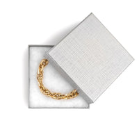 Chain bracelet in a silver jewelry box with a grid pattern
