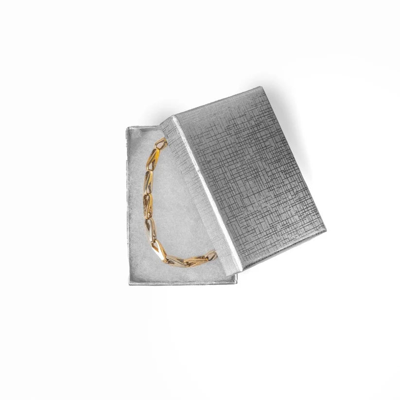 Bracelet on a textured silver surface 