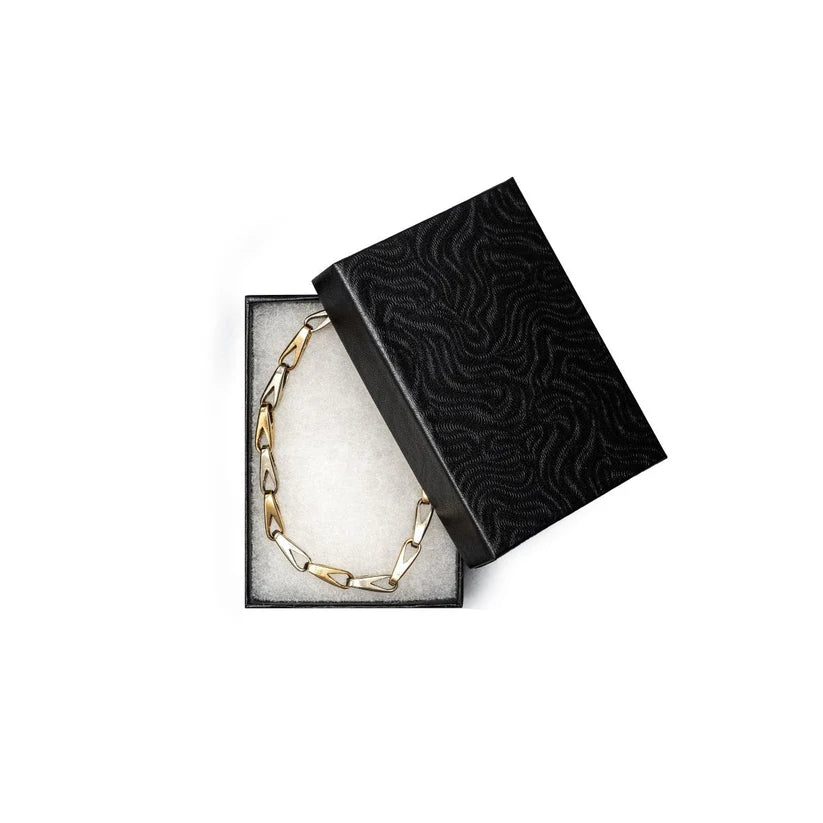 Chain necklace in an open black jewelry box 