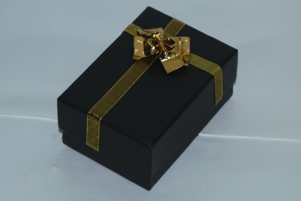 Black gift box with a gold bow