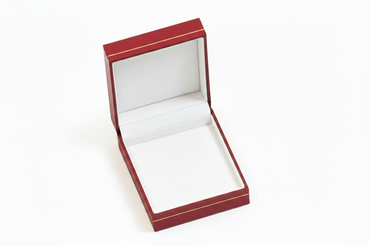 A  red leatherette drop earring box with gold trim, open and showing the interior compartment for earrings.