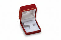 A red leatherette earring tree box with gold rim, opened to show the interior compartment, set against a plain background.