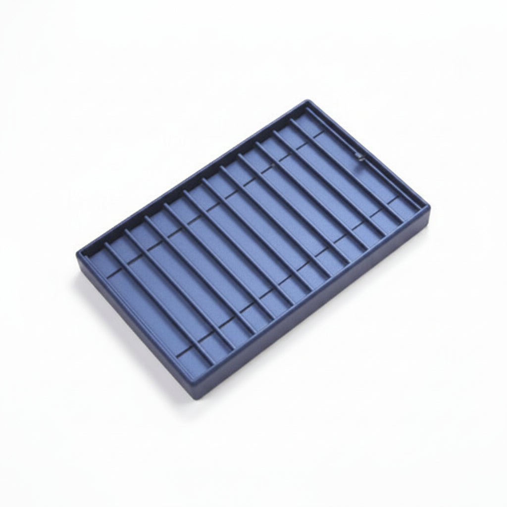 A navy blue leatherette bracelet tray with multiple compartments, designed for displaying jewelry.