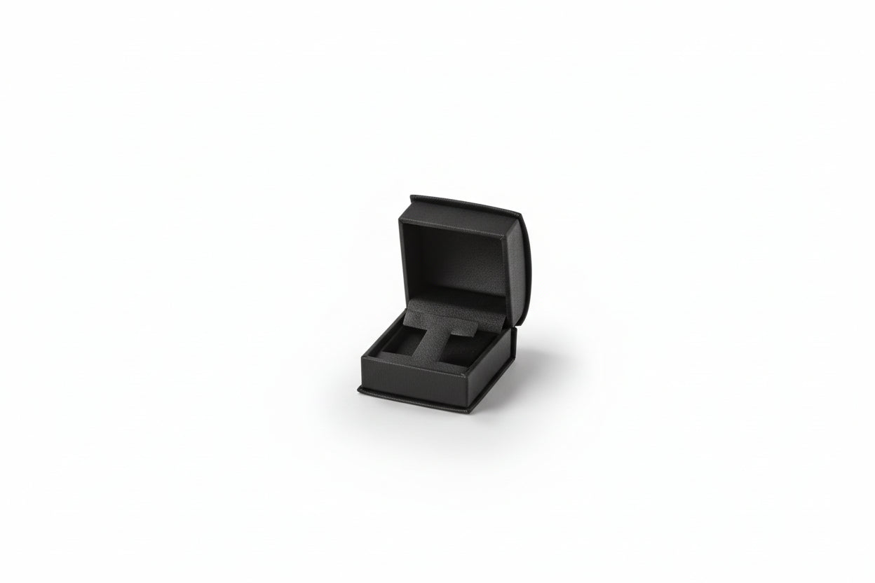 A small black leatherette roll-top jewelry box 