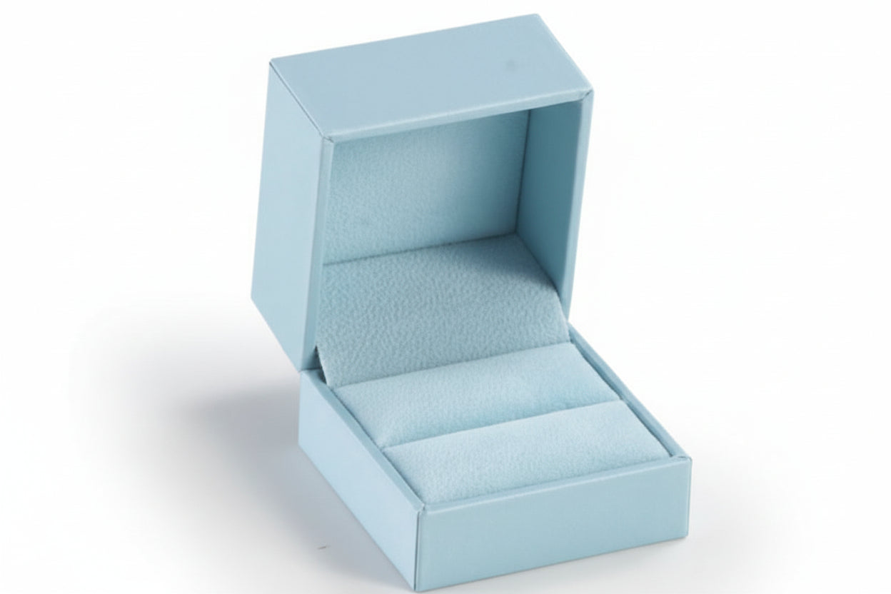A light blue leatherette ring slit box is open, showing a light blue suede interior.