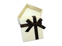 A beige cardboard stud earring box with a bow.