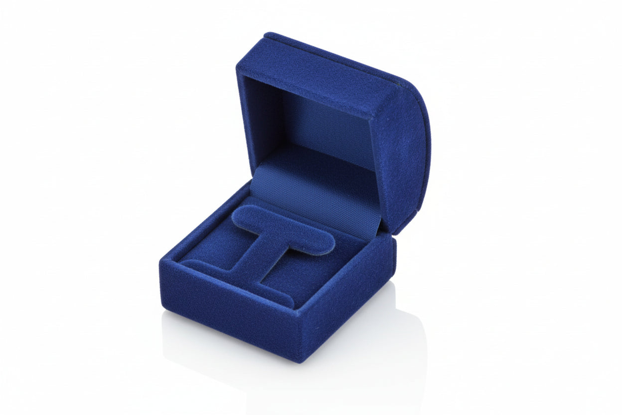 A small navy blue leatherette roll-top jewelry box with a two-piece packer and satin ribbon.