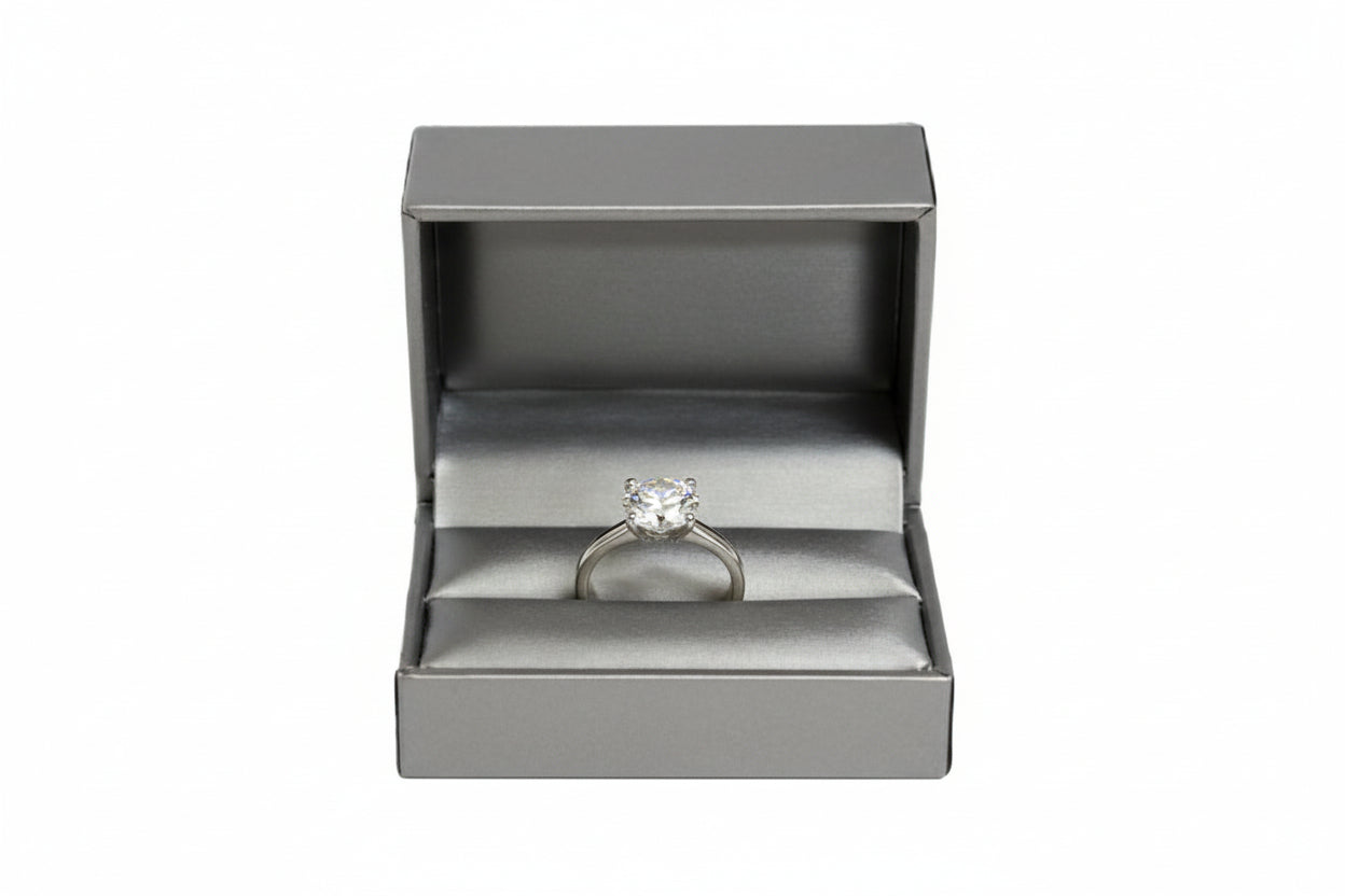 A silver leatherette double ring slit box opened to show the interior compartments