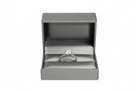 A silver leatherette double ring slit box opened to show the interior compartments