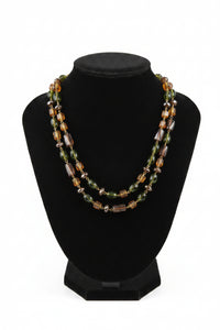 Multicolored beaded necklace on a Black Velvet display stand
