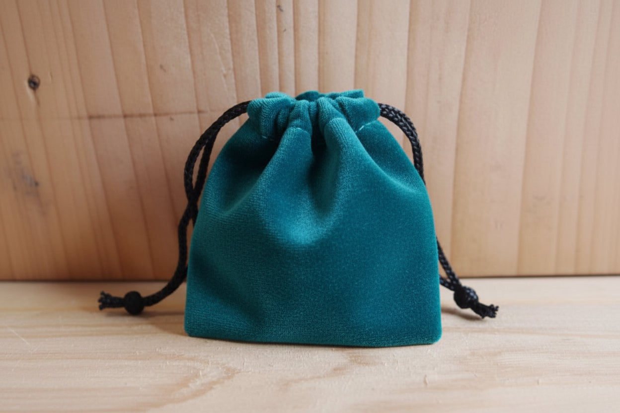 turquoise drawstring pouch on a wooden surface